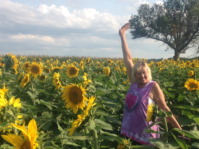 Julie in a field of Kansas sunflowers